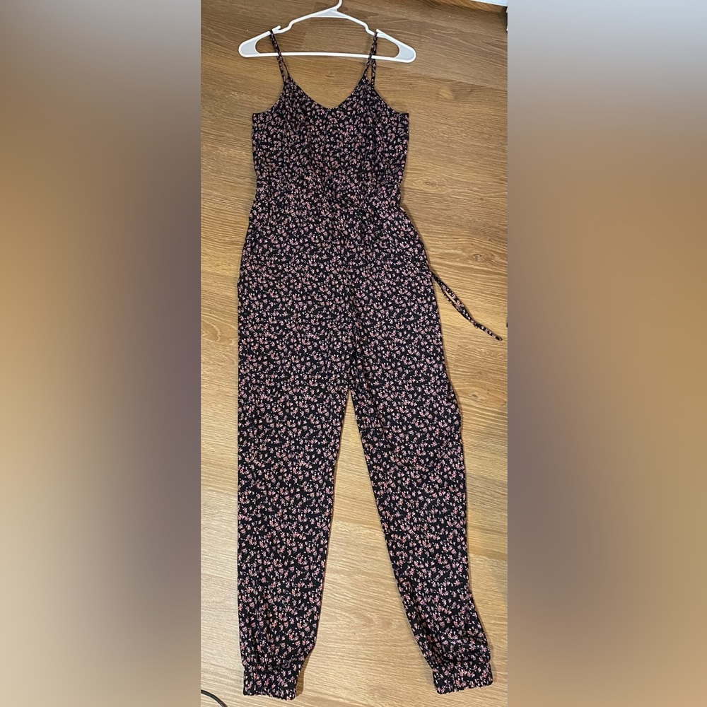 A black jumpsuit with pink flowers
